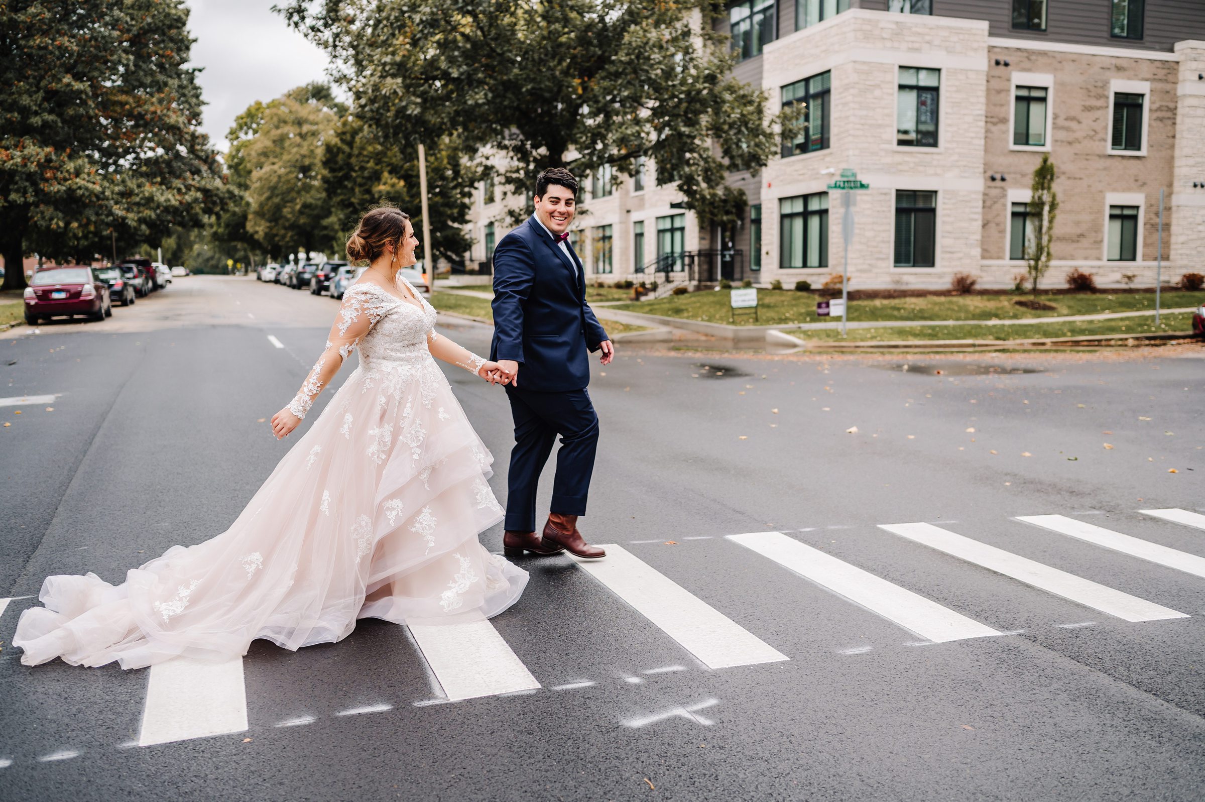 bride and groom crossing street in downtown champaign, il