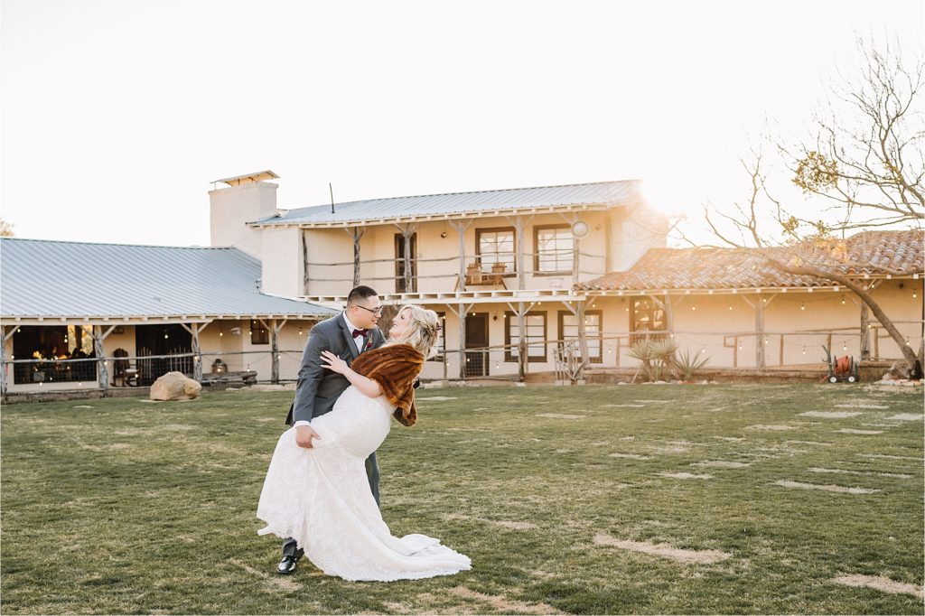 groom dipping his bride at rest yourself river ranch wedding venue in mineral wells, tx
