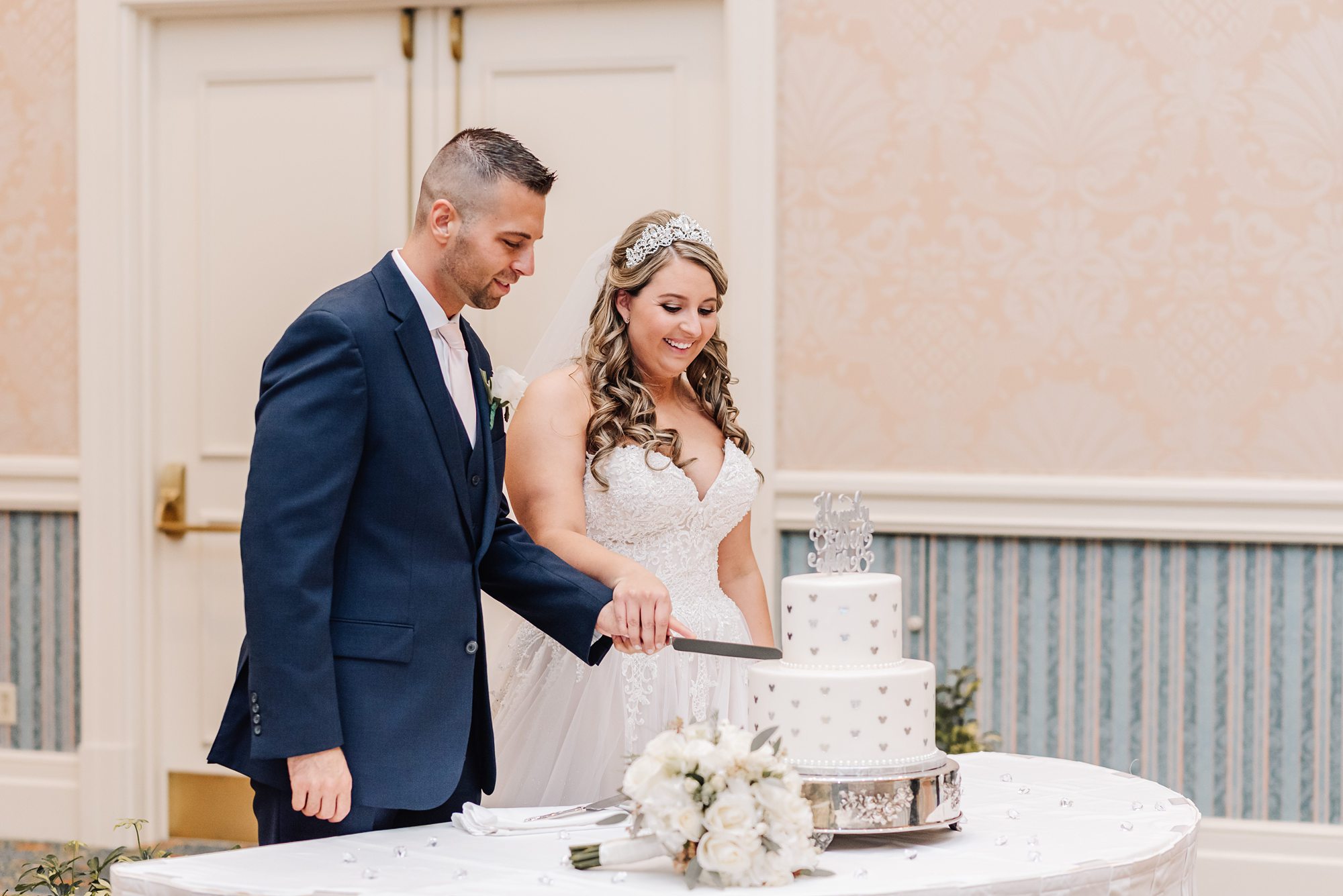 bride and groom cutting disney wedding cake