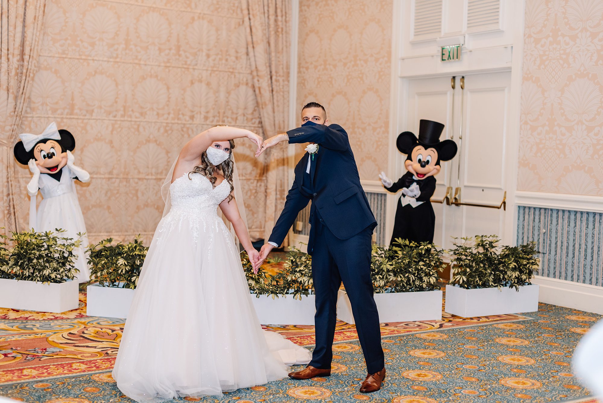 bride and groom with mickey and Minnie Mouse