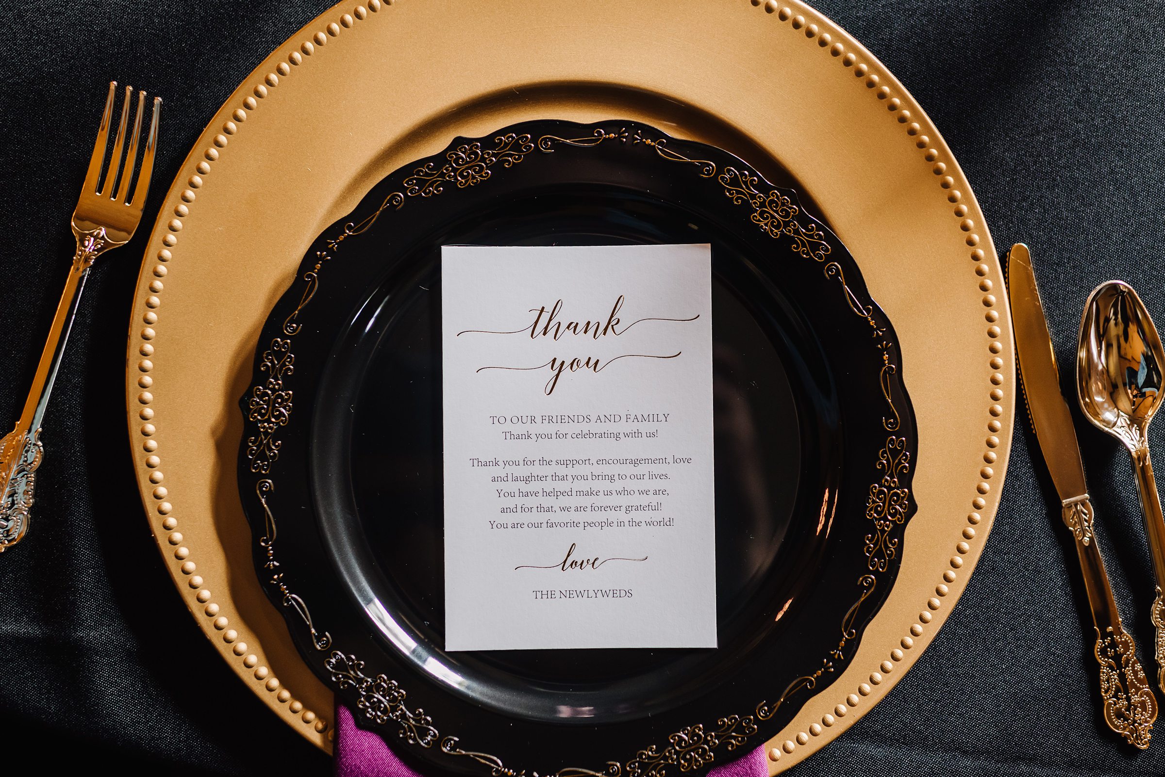 table settings for black purple and gold wedding