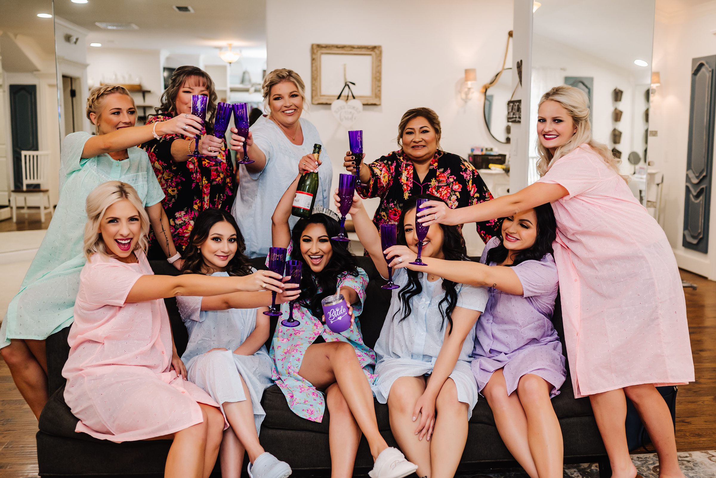 bride and bridesmaids in matching mumus drinking champagne