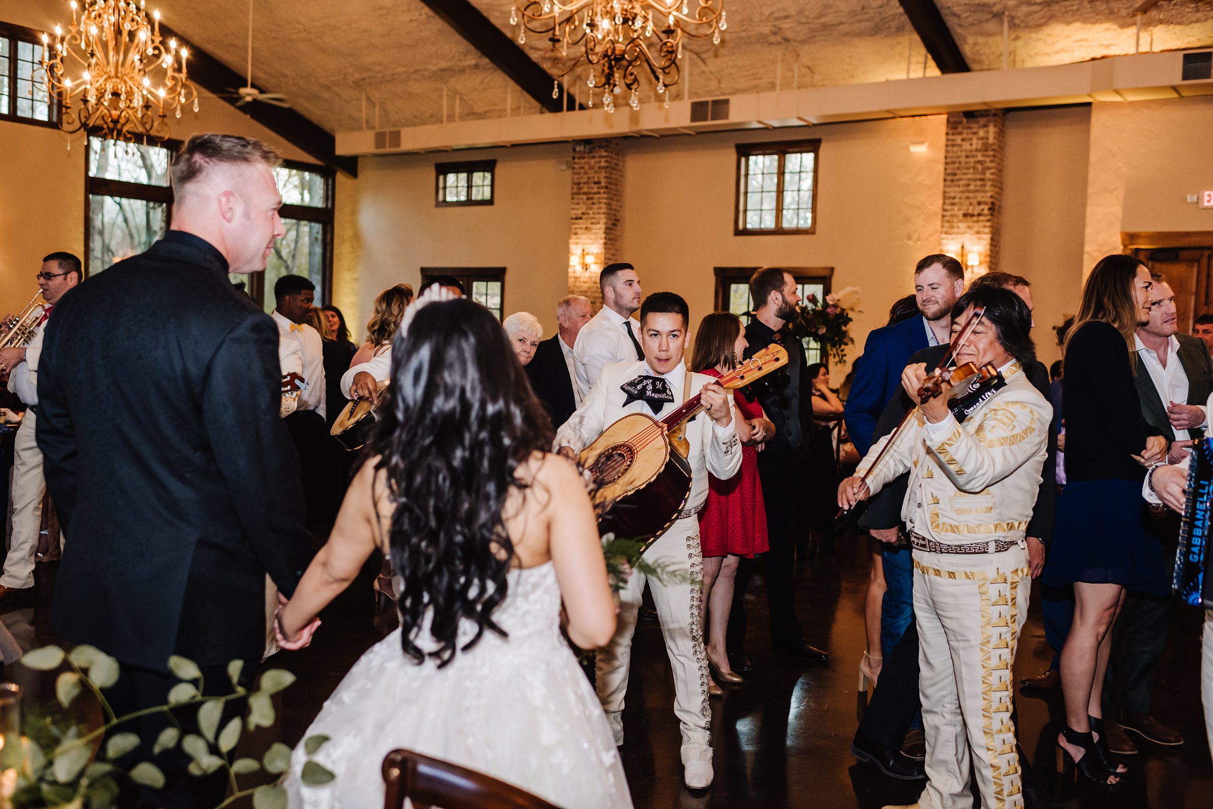 bride and groom listening to mariachi band at wedding
