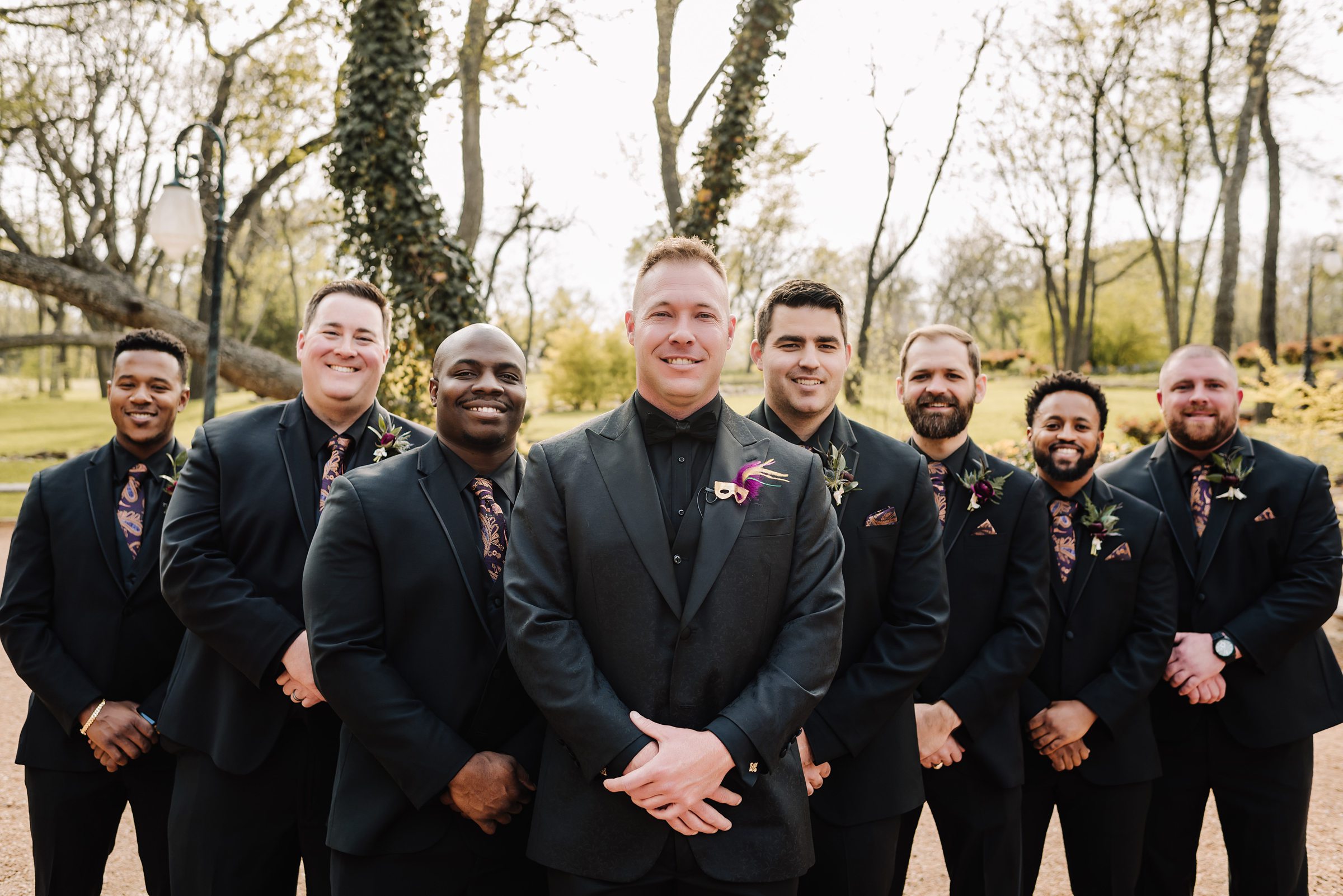 groom and groomsmen in all black suits