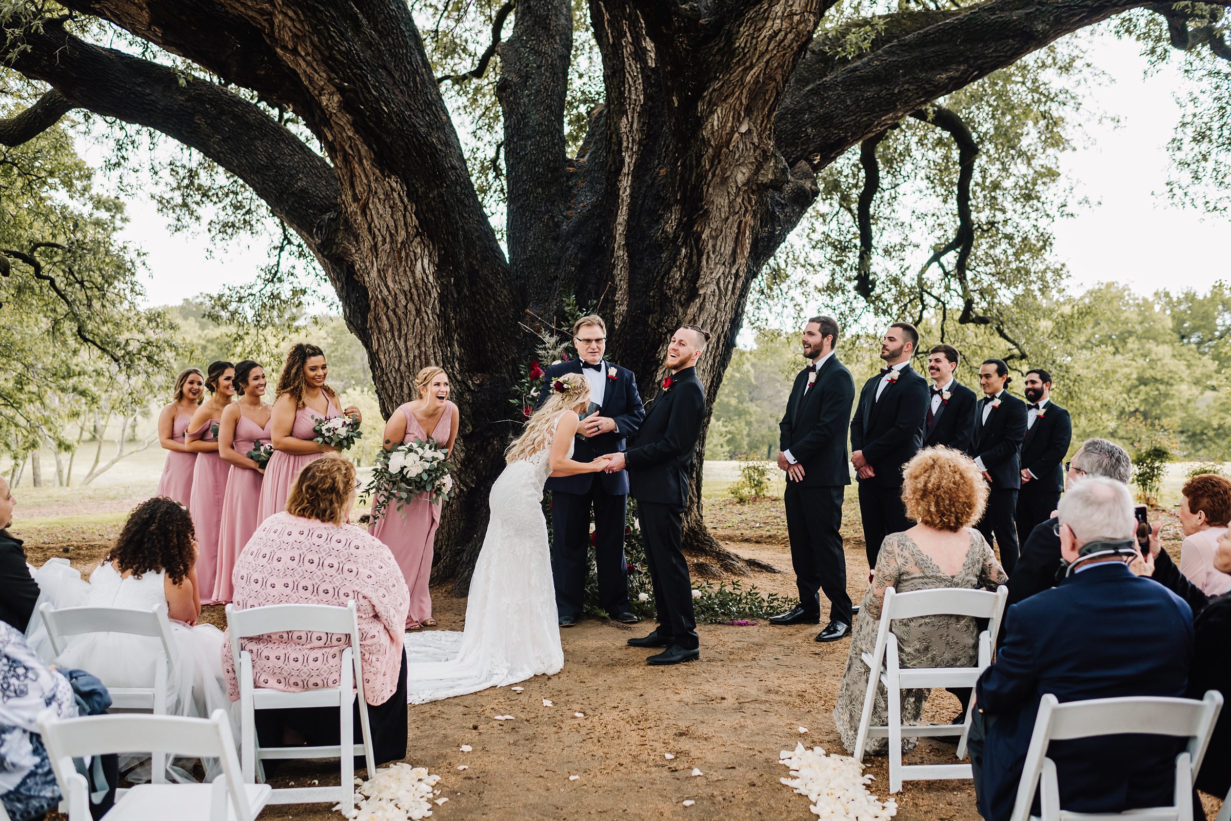 wedding ceremony under oak tree at stonebridge wedding venue