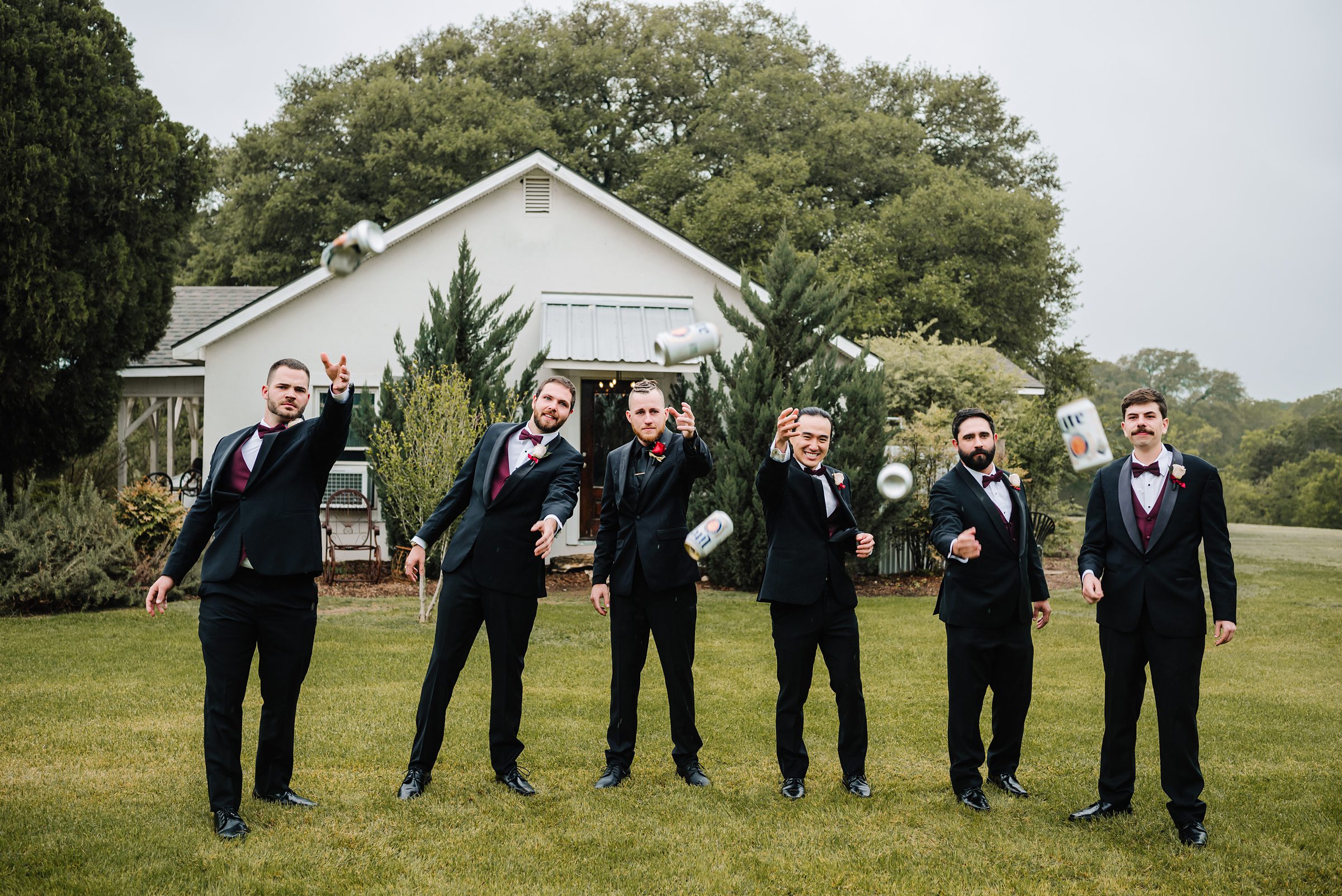 groomsmen throwing beer cans at stonebridge wedding venue