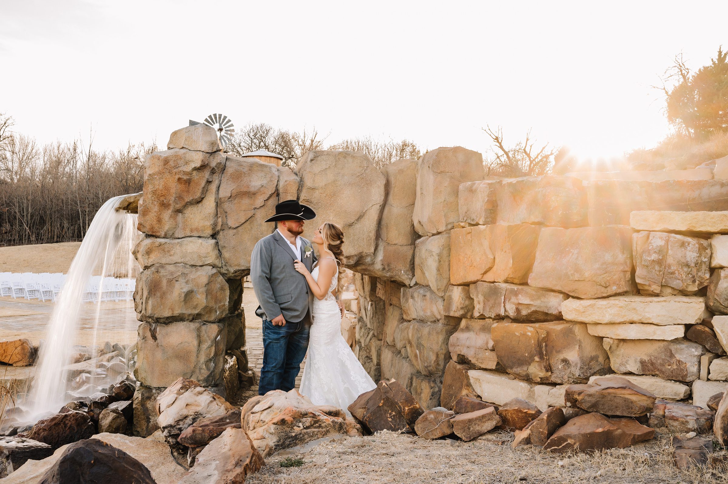 bride and groom at sunset with waterfall at covered bridge venue