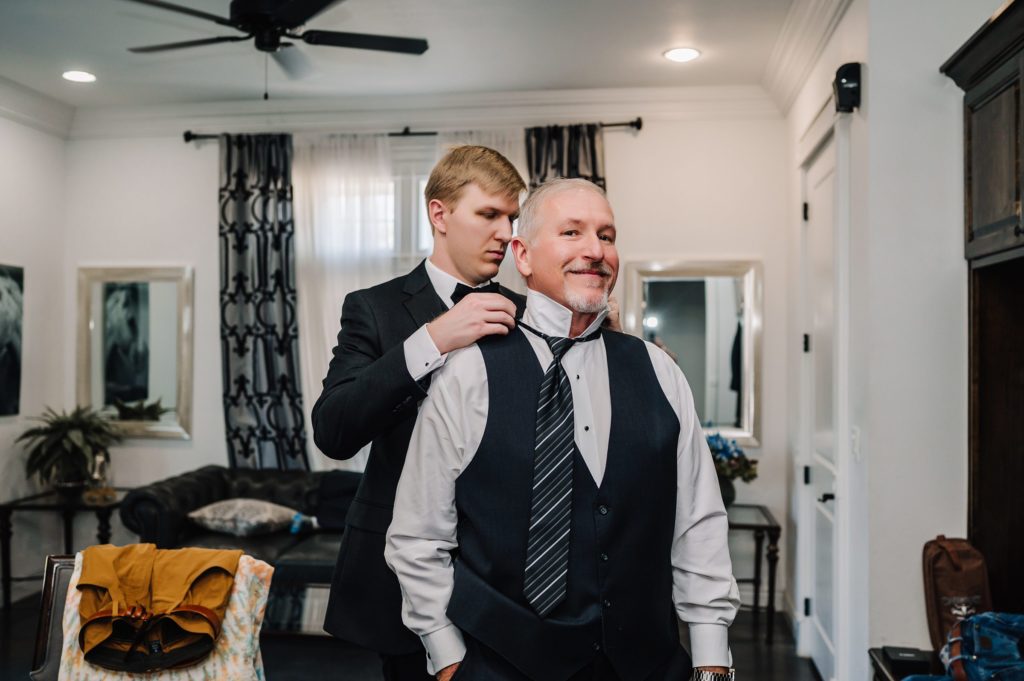 groom getting ready with dad