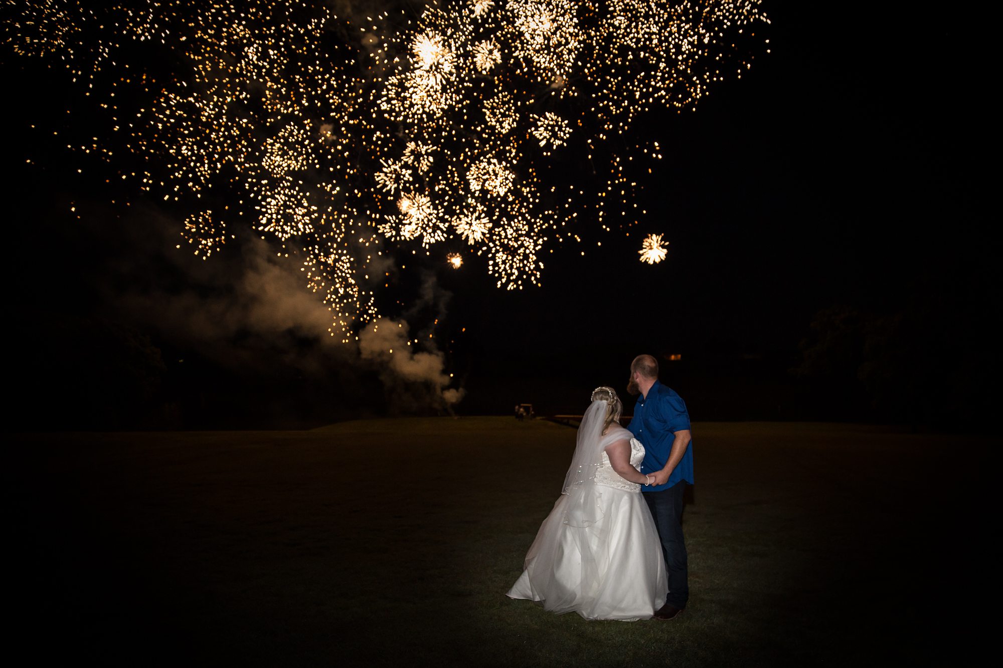 bride and groom with fireworks