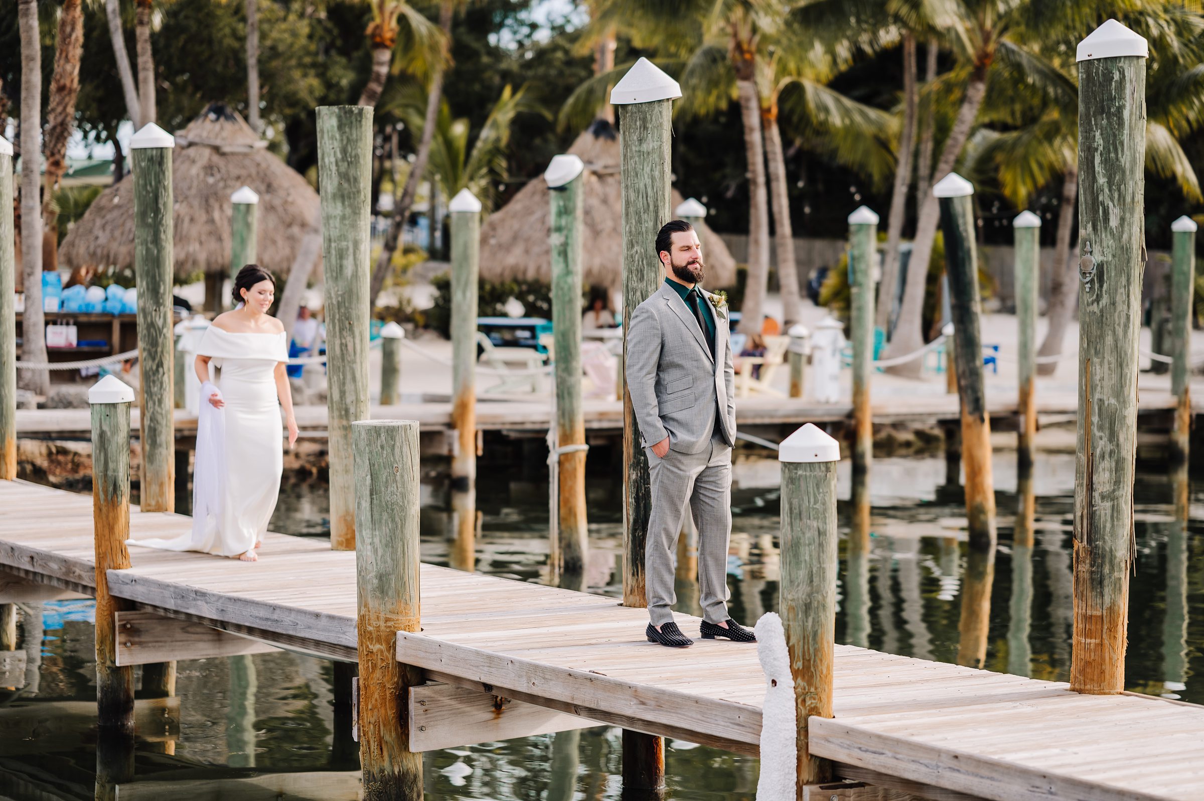 Bride and groom sharing a first look on the dock at Dream Bay Resort.