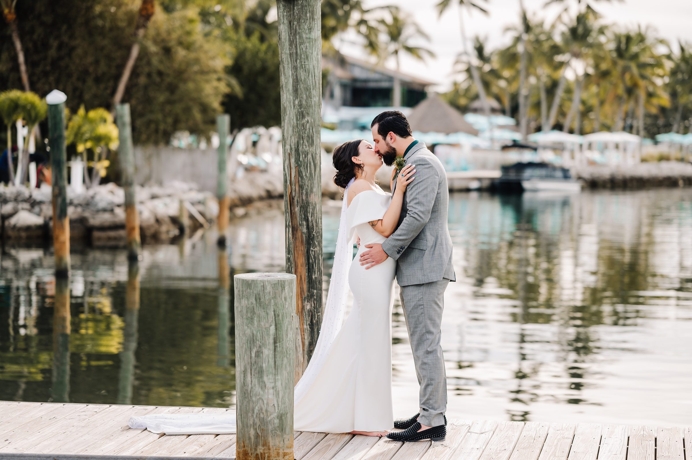 Bride and groom sharing a first look on the dock at Dream Bay Resort.
