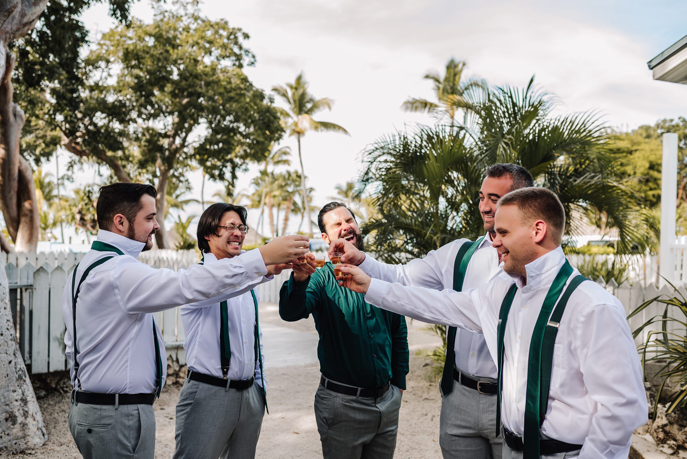 Groomsmen toasting to the happy couple at a beachside wedding location in Key Largo.
