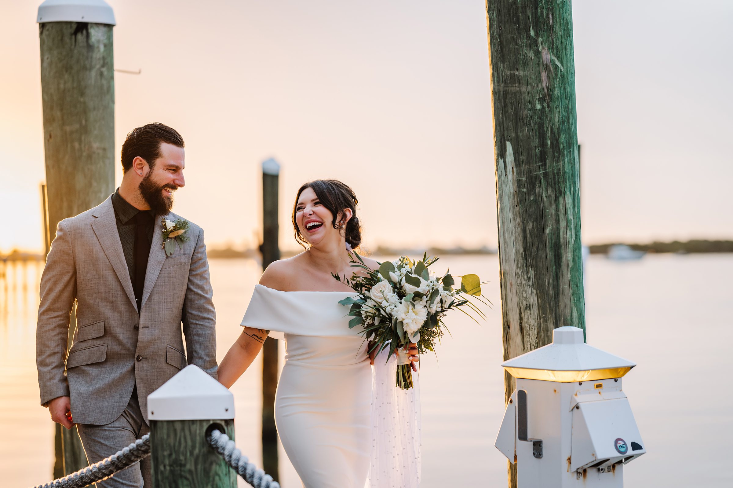 Newlyweds walking on a Dream Bay Resort dock overlooking the Florida Keys waters.